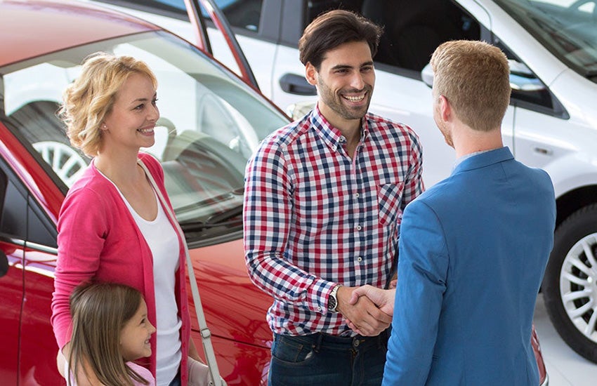 customers shaking hands with salesman